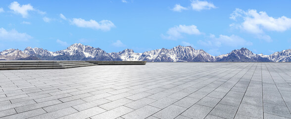 Empty square floor and mountains under blue sky. Road and mountain background.