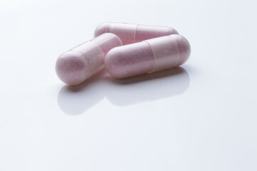 close up of medical capsules on white background