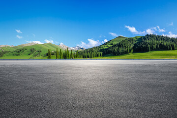 Empty asphalt road and mountain under blue sky
