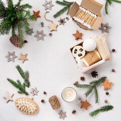 Winter Christmas gift box with plastic free cosmetics products on white natural background, top view, copy space.