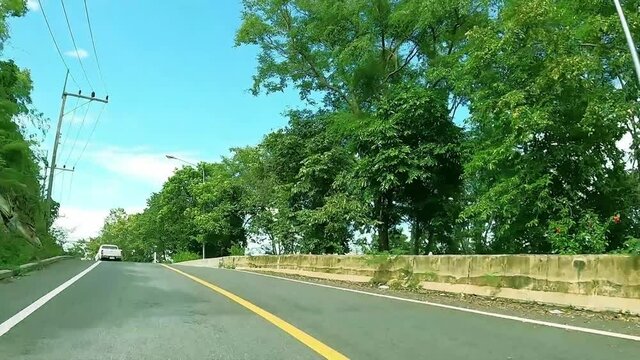 road in countryside forest with ocean sea view