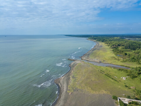 Drone view of the beach with black magnetic sands in Georgia. Aerial photography, black sand beach, waves, island, lifestyle, locality. Coastline.