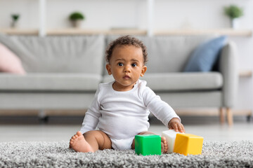 Developmental Toys Concept. Cute Little Black Infant Boy Playing With Building Blocks