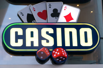 close-up of the illuminated neon sign of the casino. Text casino neon backlight. - obrazy, fototapety, plakaty