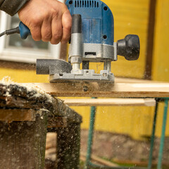 Processing the edge of the board with a milling machine.