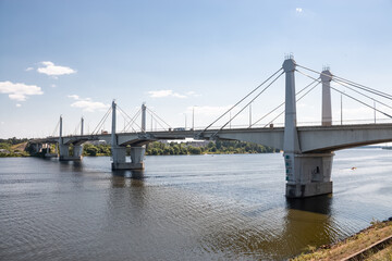 Fototapeta na wymiar Automobile bridge over the Volga River, which connects the cities of Savelovo and Kimry, Tver region, Russia