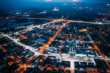Brest, Belarus. Top View Of Cityscape Skyline City In Night Illuminations. Aerial View Of Lenin Square, Lenin Street, Stadium In Evening Illumination