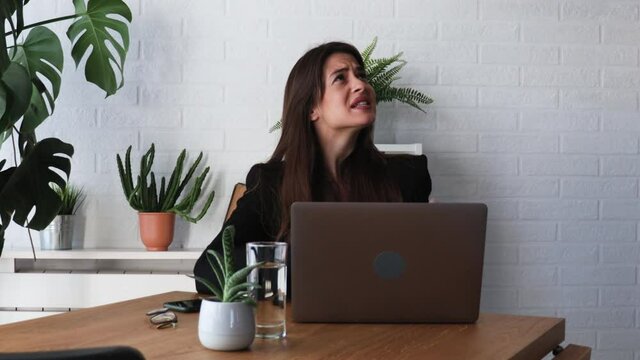 Young woman shouting trying to not to hear the loud noise from neighbor apartment in building while they renovate home and she cant work on laptop or study for school exam because of the noise