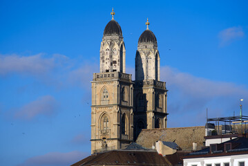 Close-up of church Great Minster at City of Zürich with blue cloudy autumn sky. Photo taken November 21st, 2021, Zurich, Switzerland.