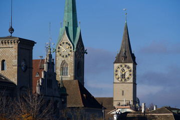Women's Minster church and St. Peters Church at the old town of Zürich on a blue cloudy autumn day. Photo taken November 21st, 2021, Zurich, Switzerland.