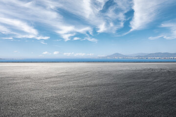 Asphalt road and sea scenery, road and sky background.