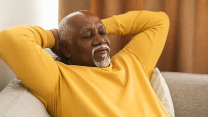 Senior Black Man Sleeping Holding Hands Behind Head At Home