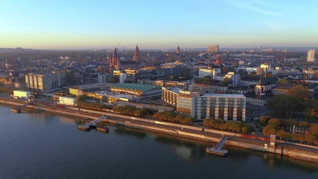 Drone video over the Rhine and Mainz waterfront with Theodor Heuss Bridge in the morning during sunrise
