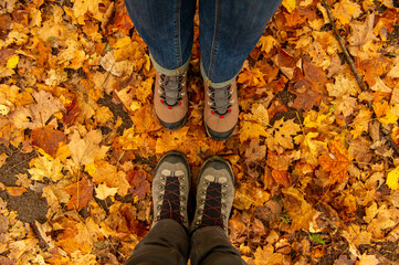 Couple Man and Woman Feet in Love Romantic Outdoor with Autumn leaves on background Lifestyle Fashion concept