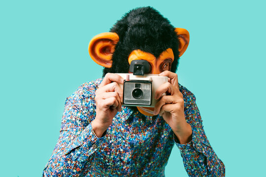 monkey man takes a picture with an instant camera