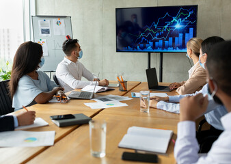 Group Of Multicultural Colleagues Wearing Medical Masks Having Business Meeting In Office