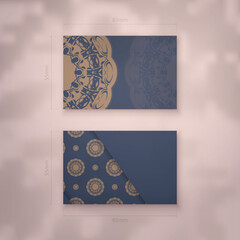 Business card in blue with Indian brown ornaments for your brand.