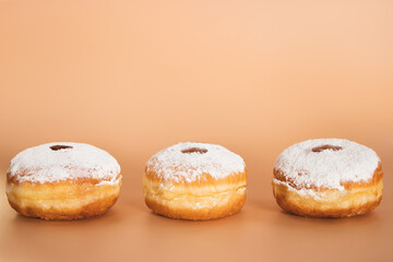 Happy Hanukkah. Traditional Jewish dessert Sufganiyot. Celebrating Judaism holiday. Donuts with jam and sugar powder.