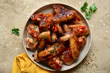 Grilled spicy chicken wings. Top view with copy spase.