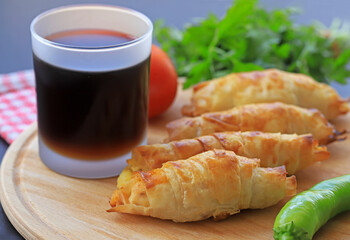 A pastry with potatoes inside, which is wrapped in a roll of pastry.