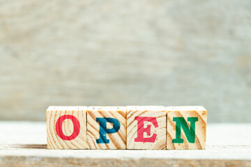 Alphabet letter block in word open on wood background