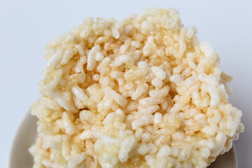 Rengginang, traditional crackers from Indonesia, made from sticky rice which dried then fried. On a white plate. Isolated on white background.
