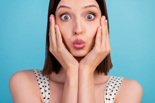 Cropped photo of crazy lady in love hands cheeks blow air kiss wear dotted overall isolated blue color background