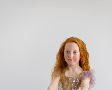 head and shoulders of little girl wearing sequinned dress
