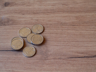 Ukrainian coins are on a wooden table. 2 hryvnia