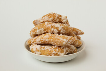 Widaran manis, also called telur gabus manis. Indonesian traditional snack. Fried dough then glazed with melted sugar. Isolated on white background.