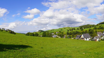 Fototapeta na wymiar Landscape in the Sauerland near Oberhenneborn. Panoramic view of the green nature with hills and forests. 