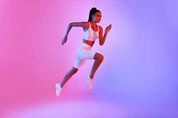 Fototapeta na wymiar Fitness Lady Jumping Running In Mid-Air Over Neon Background