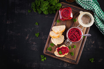 Vegetarian food. Jar with beetroot pate. Healthy eating. Sandwiches with beetroot and walnut pate. Top view, overhead