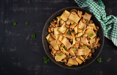 Pasta Calamarata with chicken meat, mushrooms and soy sauce. Italian cuisine. Top view, overhead