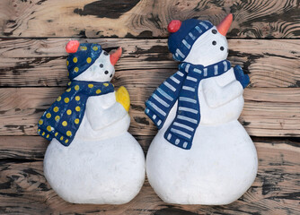 decorative snowman on wooden background