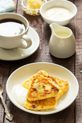 Breakfast of cheesecakes, coffee and tea. Cheesecakes of an unusual triangular shape.
