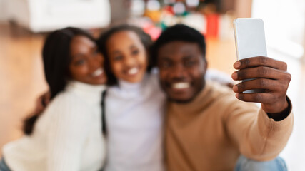 Obraz premium Happy black family of three people taking selfie