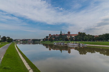 Fototapeta na wymiar The Vistula River and the Wawel Hill with the historic building of the Royal Castle in Krakow, Poland.