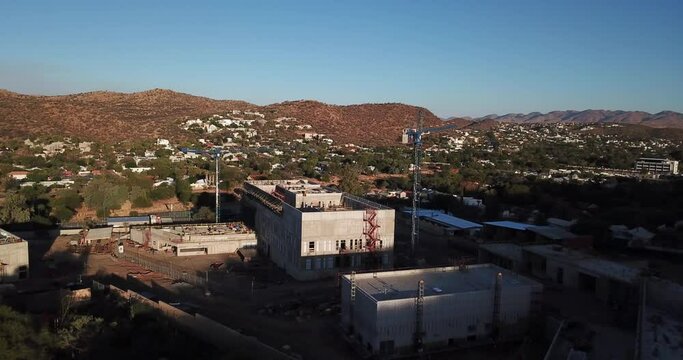 4K aerial Windhoek capital residential central hilly district bright sunset drone video with upmarket houses and old white walls German mansion on top of hill in Khomas Region, central Namibia