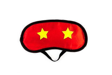 Red sleep mask on a white background. The concept of healthy sound sleep