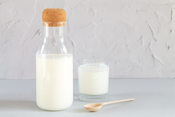 Jar of organic yogurt or kefir with glass and spoon
