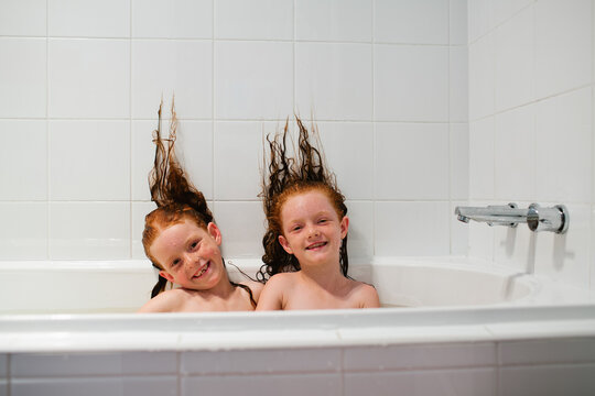 Two girls sitting in a bath