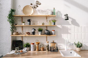 Scandinavian style shelves in kitchen in white tones
