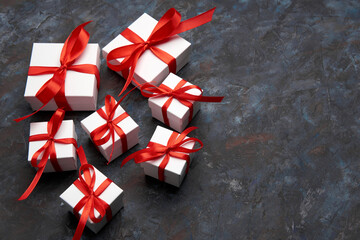 White gift box with red ribbon bow. White box with red ribbon. Gift for Christmas, New Year, Birthday, Valentine's Day. 