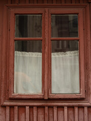 Old glass window in a wooden frame. Old window in a wooden house.