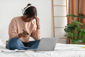 Tired African Woman Touching Head Working On Laptop At Home