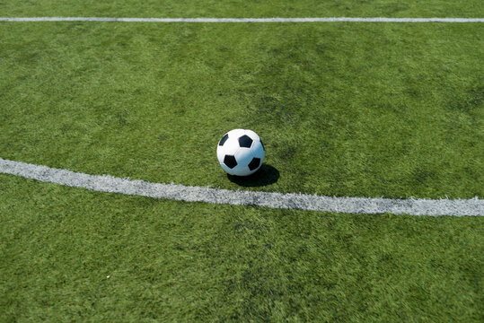A Traditional soccer ball on soccer field
