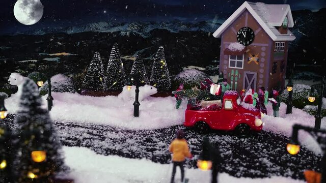 Christmas and New Years Eve 2022. It is snowing in Christmas village, magical winter scenery with Santa. Stop motion animation witg festive Christmas city and mountains at night. Holiday greetings.