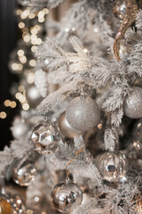 christmas tree decorations in silver white color palette. Silver shiny christmas tree.