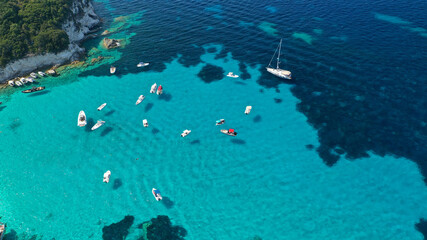 Aerial photo of luxury sail boat anchored in tropical Caribbean rocky turquoise colour seascape